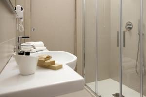 a bathroom with a sink and a shower at Ruffini Rooms in Termoli