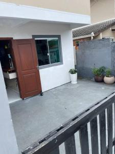 弗洛里亚诺波利斯Apartamento ingleses do rio vermelho Florianópolis的门廊,门廊,有门,有植物