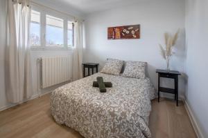 a bedroom with a bed with a teddy bear on it at The Sunrise, Spacious, fully equipped, 2 parkings, 8p, tramway 1,2,4 in Montpellier