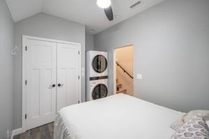 a bedroom with a white bed and a closet at Fawn Chalet in the Prescott Pines Near Downtown in Prescott
