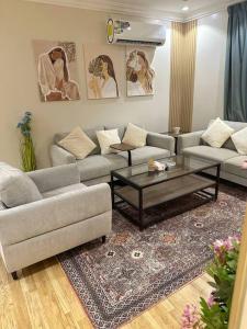 a living room with two couches and a coffee table at شقة جميلة بغرفتين نوم ودخول ذاتي 106B in Riyadh