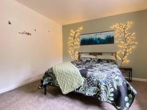 a bedroom with a bed and lights on the wall at Home Sweet Home in Grass Valley in Grass Valley