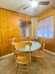 a dining room with a table and chairs and a ceiling fan at Home Sweet Home in Grass Valley in Grass Valley