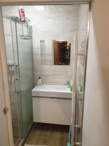 a bathroom with a shower and a sink and a mirror at Jonny room in Trnávka