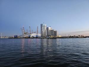 a large body of water with a city in the background at Luxury Apartment in Canary Wharf in London