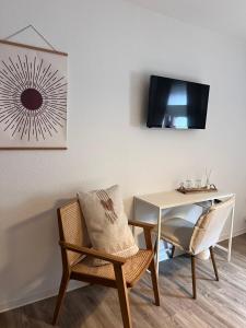 a room with a table and a chair and a desk at Pension Krone Sternenfels in Sternenfels