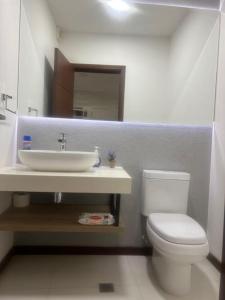 La salle de bains est pourvue de toilettes blanches et d'un lavabo. dans l'établissement Su estadía perfecta Negocio o Turismo, à Santa Cruz de la Sierra