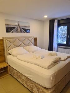 a bedroom with a bed with two rings on it at WellandHome Aalen - Private Deluxe Apartment in Aalen