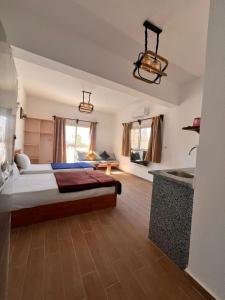 a bedroom with a large bed and a kitchen at hakuna matata in Dahab