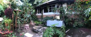 a garden with a table in front of a house at La Casa De Arturito. in Santa Lucía