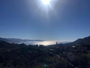 a view of a lake with the sun in the sky at La Mansarda di San Lorenzo in Santa Margherita Ligure
