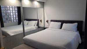 a bedroom with two beds and a mirror at DAJO Castel Lina in Cap d'Ail