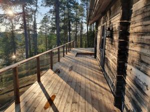 a wooden deck on the side of a house at Hilltop Villa at Lake Porontima in Kuusamo