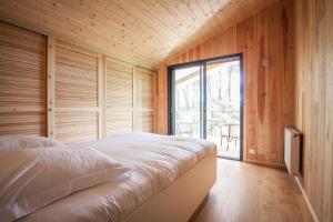 Ένα ή περισσότερα κρεβάτια σε δωμάτιο στο Villa Des Sittelles - Cap Ferret