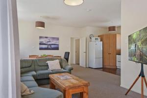 a living room with a couch and a table at 46 Scarborough Tce in Hanmer Springs