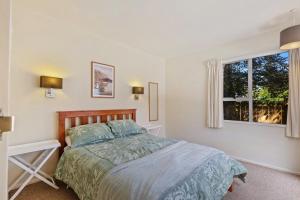 a bedroom with a bed and a window at 46 Scarborough Tce in Hanmer Springs