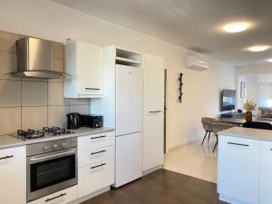 a kitchen with white cabinets and a stove top oven at Central Boutique Twenty One in Nicosia