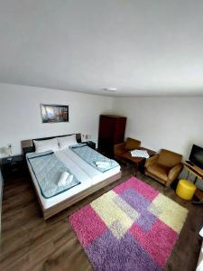 a bedroom with a large bed and a rug at Apartmani Popović in Knjazevac.