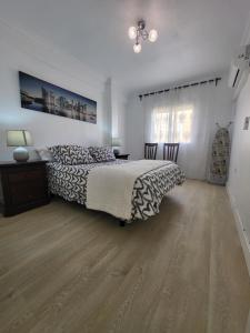 una camera con letto e pavimento in legno di Appartement centre ville Malaga a Málaga
