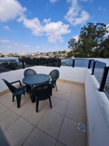 a patio with a table and chairs on a roof at Hotel Avelar in Ribeirão das Neves