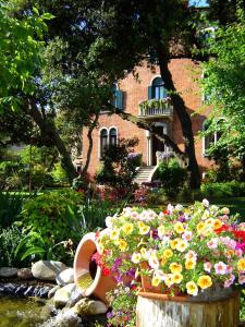 un jardin avec des fleurs devant un immeuble dans l'établissement B&B Villa Ines, sur le Lido de Venise