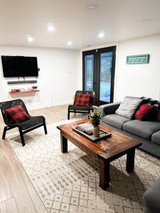 a living room with a couch and a coffee table at Waterfront Haliburton, All Season, Fully Equipped Cottage! in Haliburton