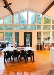 a large room with tables and chairs and windows at Waterfront Haliburton, All Season, Fully Equipped Cottage! in Haliburton +23 photos