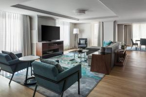 a living room with a couch and a tv at Tampa Marriott Water Street in Tampa