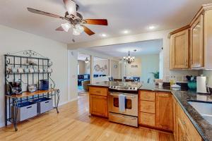 a kitchen with wooden cabinets and a ceiling fan at Nantahala in Seneca