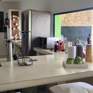 a kitchen with a counter top with a refrigerator at Casona Islas Blancas in Camarones
