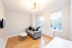 a living room with a couch and a table at Benoît Apartments in Manchester