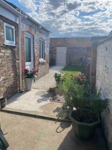 a courtyard of a brick building with potted plants at Sea view Cottage in Cleethorpes