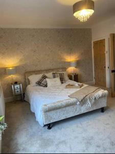 a bedroom with a large bed and two lamps at Sea view Cottage in Cleethorpes