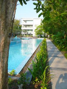 a swimming pool in front of a building at Baan San Dao Hua Hin in Hua Hin