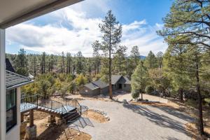 an aerial view of a house with a driveway and trees at Fawn Chalet in the Prescott Pines Near Downtown in Prescott