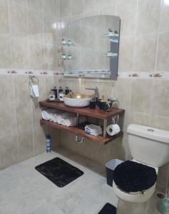 ein Badezimmer mit einem WC, einem Waschbecken und einem Spiegel in der Unterkunft Y Beautiful and comfortable in Moca