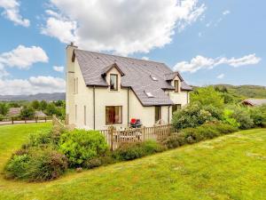 a white house with a black roof at 4 Bed in Badachro CA390 in Strath