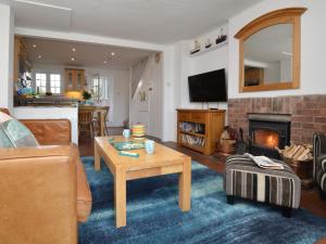 a living room with a couch and a fireplace at 2 Bed in Charmouth DC077 in Charmouth