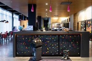 a rock wall in a restaurant with a climbing wall at Moxy Aberdeen Airport in Dyce