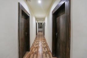 a hallway with two wooden doors and a long corridor at OXY Royal Residency in Rānchī