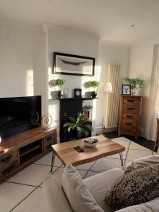 a living room with a couch and a coffee table at Hill Grove 2 Bedroom Apartment in Southend-on-Sea