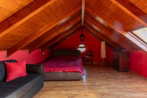 a room with a bed and a couch in a attic at Villa Lumière- Avantes in Áyioi Apóstoloi