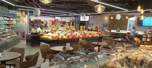 a store with tables and chairs in a grocery store at Ocean view 8min from the beach Dubai Marina JBR " My Home " in Dubai