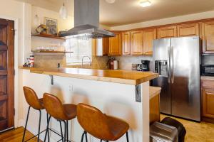 a kitchen with wooden cabinets and a stainless steel refrigerator at Deep Blue Seaside in Monterey
