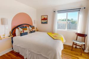 a bedroom with a large bed and a window at Deep Blue Seaside in Monterey