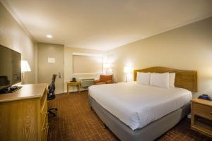 a hotel room with a bed and a desk at Best Western Inn in Redwood City