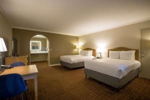 a hotel room with two beds and a desk at Best Western Inn in Redwood City