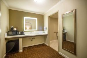 a bathroom with a sink and a microwave at Best Western Inn in Redwood City