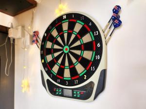 a dartboard hanging on a wall with darts at Loft Suite CityView near JB CIQ 7Pax in Johor Bahru