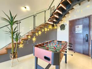 a large foosball table in a room with stairs at Loft Suite CityView near JB CIQ 7Pax in Johor Bahru